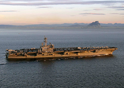 The United States ordered an aircraft carrier into the Persian Gulf and laid out specific ways for Iraq to show it is forging the national unity necessary to gain assistance in its fight against Islamic insurgents. Reuters