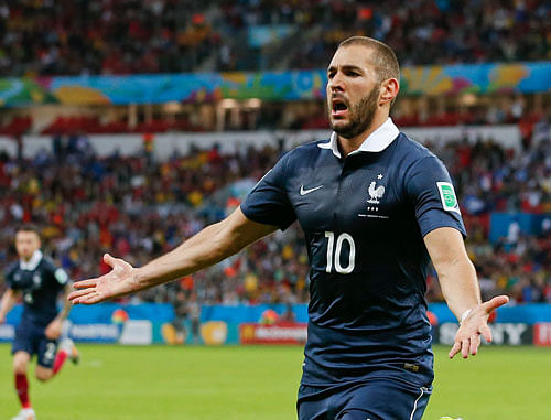 France's Karim Benzema celebrates after scoring his side's third goal during the group E World Cup soccer match between France and Honduras at the Estadio Beira-Rio in Porto Alegre, Brazil, Sunday, June 15, 2014. AP