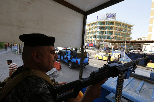 A member of the Iraqi security forces guards a checkpoint during an intensive security deployment in Baghdad, June 16, 2014. Reuters file photo