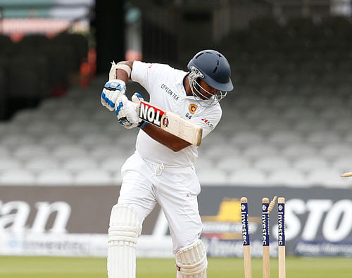 Sri Lanka's Kumar Sangakkara is clean bowled by England's James Anderson on the fifth day of the first Test cricket match between England and Sri Lanka at Lord's cricket ground in London, Monday, June, 16, 2014. AP