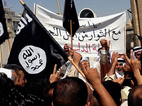 Demonstrators chant pro-al-Qaida-inspired Islamic State of Iraq and the Levant (ISIL) as they wave al-Qaida flags in front of the provincial government headquarters in Mosul, 225 miles (360 kilometers) northwest of Baghdad, Iraq, Monday, June 16, 2014. Sunni militants captured a key northern Iraqi town along the highway to Syria early on Monday, compounding the woes of Iraq's Shiite-led government a week after it lost a vast swath of territory to the insurgents in the country's north. AP