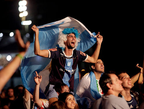 Argentina soccer fans cheer during halftime entertainment at the FIFA Fan Fest area on Copacabana beach in Rio de Janeiro, Brazil, during their team's World Cup soccer match between Argentina and Bosnia, Sunday, June 15, 2014. AP