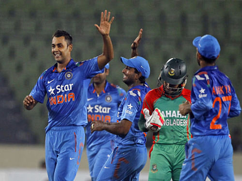 Stuart Binny, celebrates with teammates after the wicket of Bangladesh's captain Mushfiqur Rahim, during their second one-day International cricket match in Dhaka. AP photo