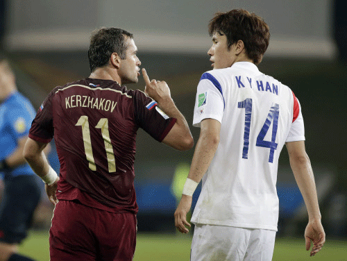 Russia's Alexander Kerzhakov, left, gives a quiet sign to South Korea's Han Kook-young during the group H World Cup soccer match between Russia and South Korea at the Arena Pantanal in Cuiaba, Brazil. AP photo