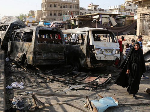 Iraqi civilians inspect damage in the aftermath of a car bombing that killed many people and wounded tens of others in a crowded outdoor market, in Baghdad's Sadr City. Turkey's Foreign Ministry says its embassy in Baghdad is looking into reports that Islamic militants in Iraq have abducted 60 foreign construction workers near the city of Kirkuk. AP photo