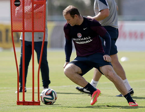 England national soccer team player Wayne Rooney takes part in a squad training session for the 2014 soccer World Cup at the Urca military base in Rio de Janeiro, Brazil, Monday, June 16, 2014. aP