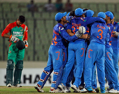 The Indian cricket team gather to celebrate after their victory over Bangladesh on their second one-day International cricket match in Dhaka, Bangladesh. AP