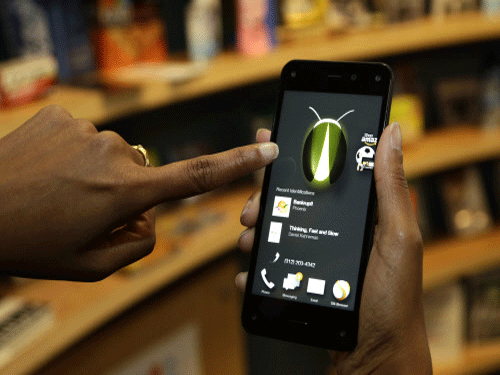 The new Amazon Fire Phone's Firefly feature, which lets the user take a photo of objects, numbers, artwork or books and have the phone recognize the item, is demonstrated. AP photo