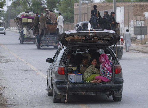 Children fleeing the military offensive against the Pakistani militants in North Waziristan, sit in a vehicle with their family while entering in Bannu, located in Pakistan's Khyber-Pakhtunkhwa province June 18, 2014. After months of dithering, Pakistan's army has launched an offensive against Taliban insurgents near the border with Afghanistan but the tough terrain, a potentially hostile local population, and risk of revenge attacks in heartland cities could be more difficult to conquer than the militants. Pakistan announced on Sunday it was sending ground forces, artillery and helicopter gunships to the remote, mountainous tribal region of North Waziristan in a long-awaited military operation designed to eliminate the al Qaeda-linked insurgents. REUTERS