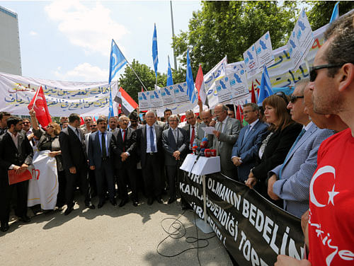 Iraqi Turkmens stage a protest to condemn the recent killings of Turkmen community members in Iraq by the militants from an al-Qaida inspired group, in Ankara, Turkey, Wednesday, June 18, 2014.Turkey's Foreign Ministry said Wednesday its embassy in Baghdad is looking into reports that Islamic militants in Iraq have abducted some 15 Turks, near the city of Kirkuk. Last week, militants from the al-Qaida inspired group seized 49 people from the Turkish consulate in Mosul and 31 Turkish truck drivers. AP