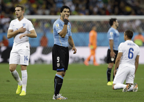 Uruguay's Luis Suarez gestures during the group D World Cup soccer match between Uruguay and England at the Itaquerao Stadium in Sao Paulo. AP photo