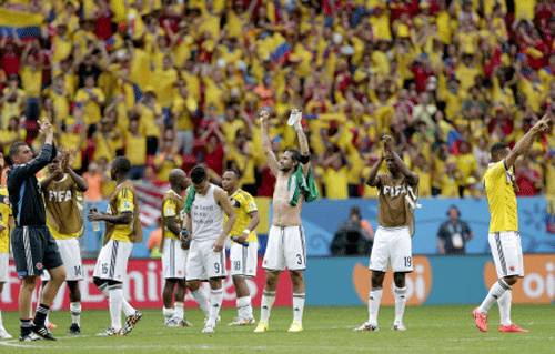 olombian players celebrate after the group C World Cup soccer match between Colombia and Ivory Coast at the Estadio Nacional in Brasilia. AP photo