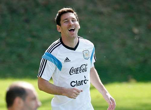 Argentina's Lionel Messi laughs during a training session in Vespasiano, near Belo Horizonte, Brazil, Friday, June 20, 2014. Argentina plays in group F of the 2014 soccer World Cup.  AP