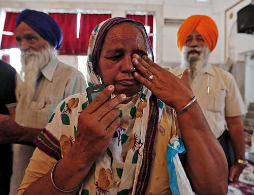 A relative of an Indian worker, who has been kidnapped in Iraq, weeps during her visit to a Gurudwara before meeting India's FM Swaraj in New Delhi. India is ''knocking on all doors'' to ensure the safety of the 39 Indians, who continue to be held captive after being kidnapped from the jihadist-held city of Mosul in northern Iraq. Reuters