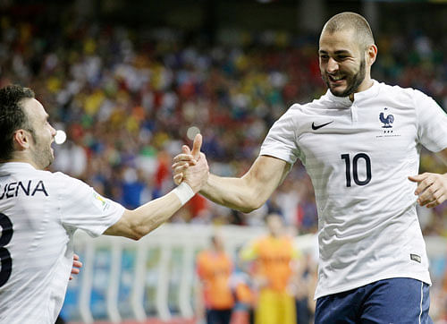 France's Karim Benzema, right, celebrates with Mathieu Valbuena after scoring his side's fourth goal during the group E World Cup soccer match between Switzerland and France at the Arena Fonte Nova in Salvador, Brazil, Friday, June 20, 2014. AP