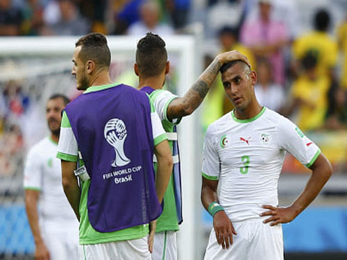 Algeria's Faouzi Ghoulam is consoled after the 2014 World Cup Group H soccer match between Belgium and Algeria at the Mineirao stadium in Belo Horizonte. Reuters photo