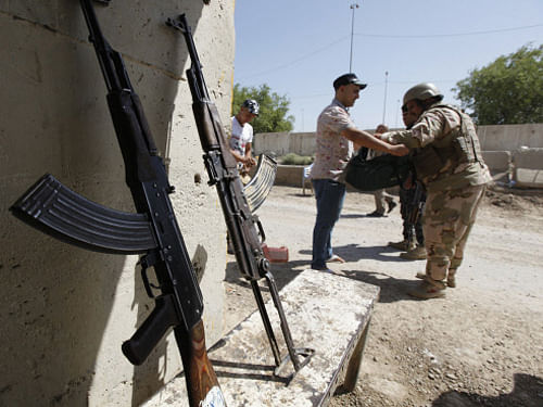 A member of Iraqi security forces searches volunteers, who have joined the Iraqi army to fight against the predominantly Sunni militants from ISIL. In the two weeks since it was seized by Sunni militants, some residents of the northern Iraq city of Mosul feel the clock has been turned back hundreds of years. Reuters photo