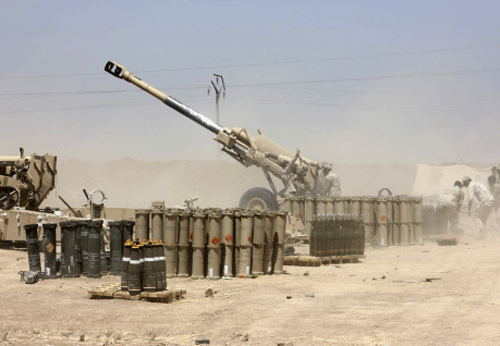 Iraqi security forces fire artillery during clashes with Sunni militant group Islamic State of Iraq and the Levant (ISIL) on the outskirts of the town of Udaim in Diyala province.  Reuters photo