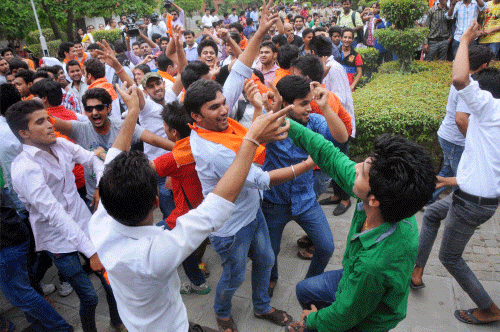 Members of Youth for Change dance as they celebrate the University Grants Commission's diktat to Delhi University on the FYUP at the university's North Campus in New Delhi on Monday. PTI Photo