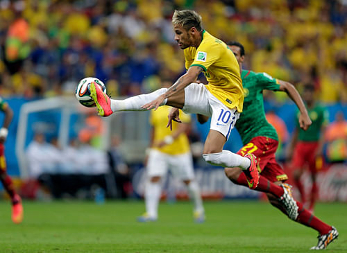 Brazil's Neymar controls a ball during the group A World Cup soccer match between Cameroon and Brazil at the Estadio Nacional in Brasilia, Brazil, on Monday.AP photo