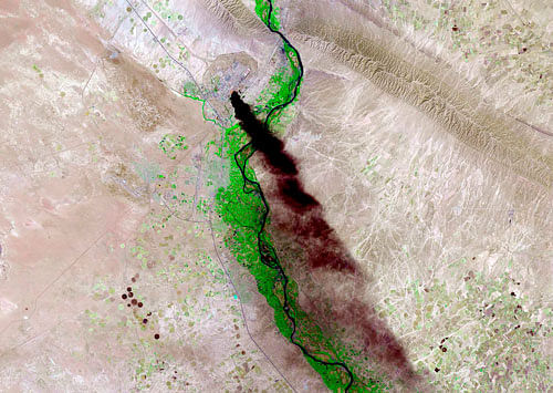 Smoke rises from the Baiji refinery near Tikrit, Iraq in this Landsat image courtesy of the U.S. Geological Survey taken on June 18, 2014. President Barack Obama said on June 19 he was sending up to 300 U.S. military advisers to Iraq but stressed the need for a political solution to the Iraqi crisis as government forces battled Sunni rebels for control of the country's biggest refinery. Image taken June 18, 2014. REUTERS