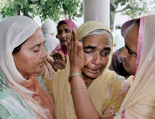 A relative is consoled during a prayer meeting for the Indian workers stranded in Iraq, at Baba Budha Ji Sahib Gurdwara at Kathunangal in Amritsar on Tuesday. PTI Photo