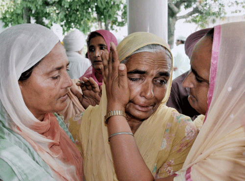 A relative is consoled during a prayer meeting for the Indian workers stranded in Iraq, at Baba Budha Ji Sahib Gurdwara at Kathunangal in Amritsar on Tuesday. PTI Photo