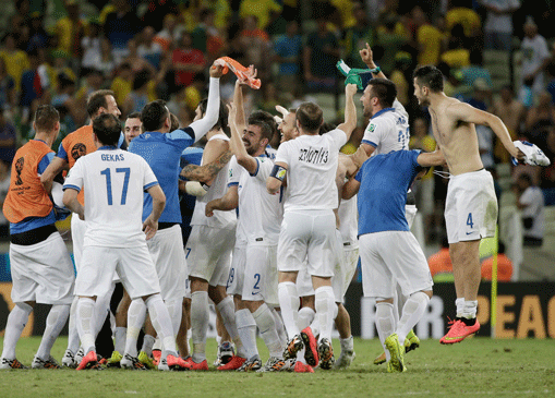 Greek players celebrate after their 2-1 victory over Ivory Coast during the group C World Cup soccer match between Greece and Ivory Coast at the Arena Castelao in Fortaleza, Brazil, Tuesday, June 24, 2014. (AP Photo)