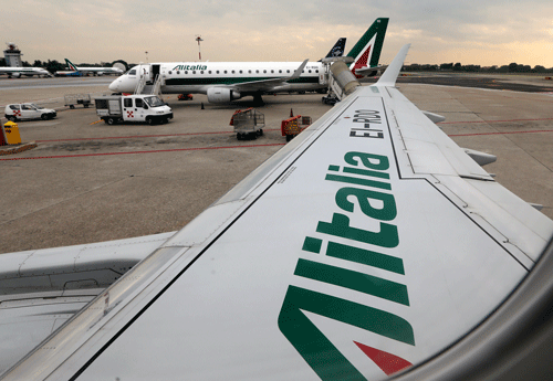 In this Wednesday, May 7, 2014, file photo, Alitalia planes wait on the tarmac prior to take off from the Linate airport, in Milan, Italy. Fast-growing Gulf carrier Etihad Airways says it and Alitalia have reached a deal in principle for the United Arab Emirates-based airline to buy a 49 percent stake in the struggling Italian airline. AP