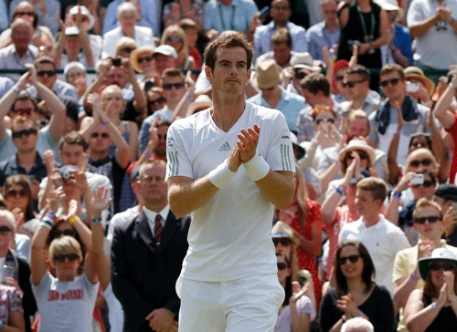 Andy Murray of Britain thanks supporters after defeating Blaz Rola of Slovenia in their men's singles tennis match at the Wimbledon Tennis Championships, in London June 25, 2014. REUTERS