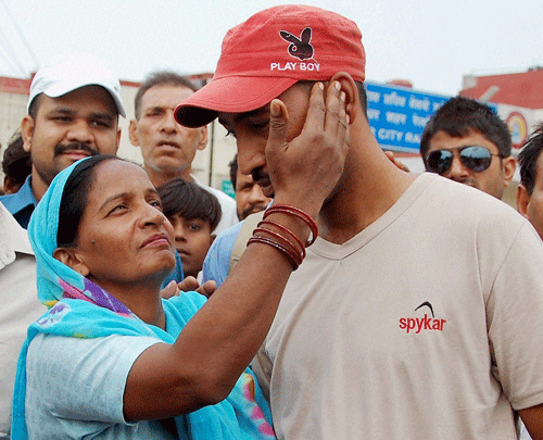 One of the workers stranded in Iraq, Vinod Kumar returns home and meets his mother in Jalandhar on Wednesday. India has evacuated two nurses, other than the 46 nurses stranded in a hospital in Tikrit, from Iraq's conflict zone taking the total number of those rescued so far to 36. PTI Photo