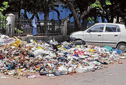 Garbage lies uncleared on 1st Main, 10 Cross, at Vasanthnagar on Wednesday. DH photo