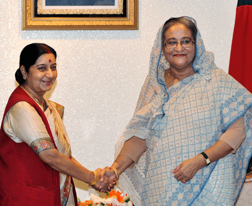 External Affairs Minister Sushma Swaraj (L) shakes hand with Bangladesh's Prime Minister Sheikh Hasina before a meeting in Dhaka June 26, 2014. Sushma Swaraj arrives in Dhaka on Wednesday night as it is the first visit by a minister of India after the new government led by Narendra Modi came to power last month with overwhelming majority, local media reported.Swaraj today held a meeting here with former Bangladesh Prime Minister and chairperson of Bangladesh Nationalist Party (BNP) Khaleda Zia. REUTERS