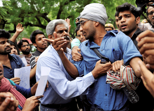 DCP S B S Tyagi detaining AISA activists who were protesting against Delhi University's FYUP outside Parliament Street police station in the New Delhi on Thursday. PTI Photo