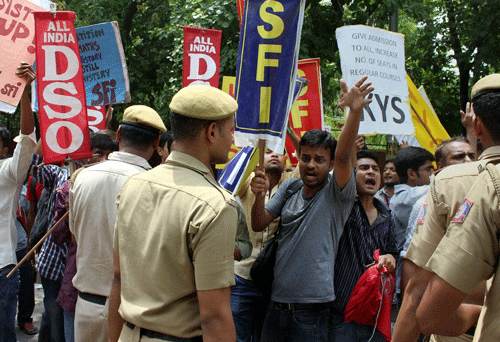Police stop students who were protesting against the four-year undergraduate programme (FYUP) of Delhi University in New Delhi on Thursday.Delhi University today wrote to the UGC, saying it was working on a response in accordance with the ''spirit of your directives'' to ensure the admission process starts very soon. PTI File Photo