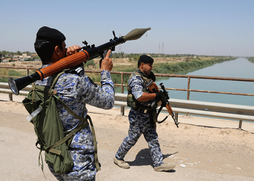 Iraqi federal policemen patrol in the town of Taji, about 12 miles (20 kilometers) north of Baghdad, Iraq, Thursday, June 26, 2014. Russia's UN ambassador said today there is a real prospect of a terrorist state springing up from Syria's second-largest city Aleppo to Iraq's capital Baghdad. Reuters
