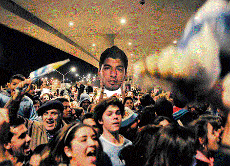 Fans throng the airport at Montevideo where Luis Suarez arrived following his ban.