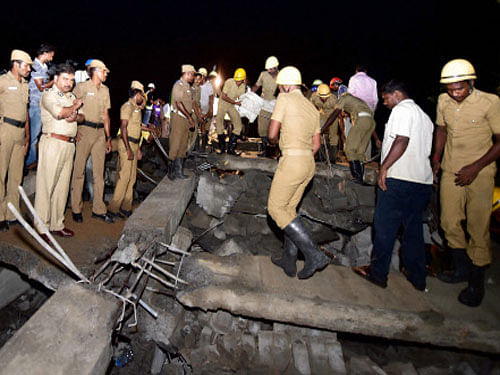 Rescuers search for survivors in the debris of under construction building which collapsed in Porur near Chennai. PTI photo