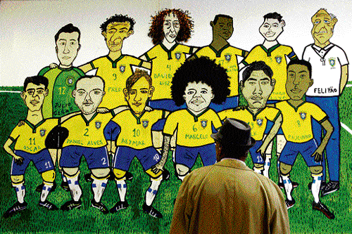 BiG hit : A football fan looks at a mural depicting the Brazilian team in Rio de Janeiro. Reuters