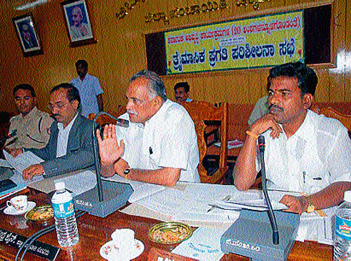 District-in-Charge Minister K Abhayachandra Jain took the officials to task for the delay in implementing development works in the district.  DH photo