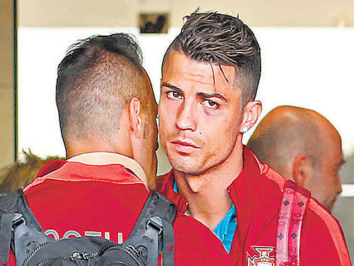 Portugal's Cristiano Ronaldo hugs team-mate Beto after arriving in Lisbon from Brazil. Reuters