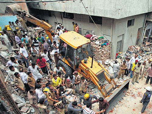 Rescue work being carried out at the site of the building  collapse in New Delhi on Saturday. AP