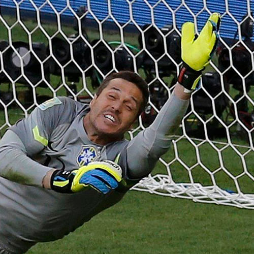 Brazil goalkeeper Julio Cesar celebrated on Saturday night after his dream performance helped erase the nightmare of the 2010 World Cup when his mistake led to Brazil's early elimination and four years of vilification by sceptical fans. / Reuters