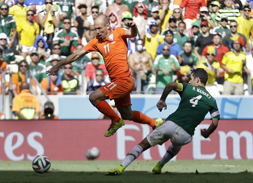 Netherlands' Arjen Robben leaps over a challenge from Mexico's Rafael Marquez during the World Cup round of 16 soccer match between the Netherlands and Mexico at the Arena Castelao in Fortaleza, Brazil, Sunday, June 29, 2014. (AP Photo)