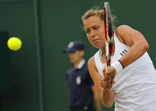 Barbora Zahlavova Strycova of the Czech Republic plays a return to Caroline Wozniacki of Denmark during their women's singles match at the All England Lawn Tennis Championships in Wimbledon, London, Monday, June 30, 2014. (AP Photo)