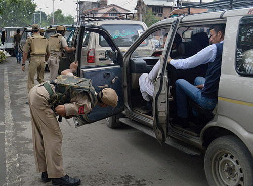 Policemen check vehicles in Srinagar on Thursday. Security has been beefed up across the valley ahead of Prime Minister Narendra Modi's visit to Jammu and Kashmir. PTI Photo
