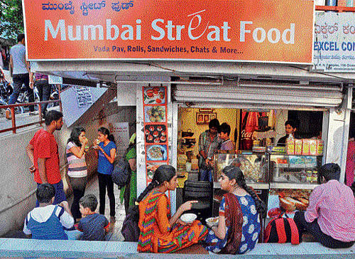 Packed:  People enjoying the snacks. DH Photos by BK Janardhan