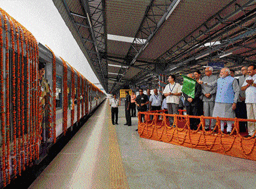 new beginning: Prime Minister Narendra Modi with Railway Minister Sadananda Gowda, Jammu & Kashmir Governor N N Vohra and Chief Minister Omar Abdullah flag off the first train (Shri Shakti Express) to Udhampur, from Katra Railway Station, on Friday. pti