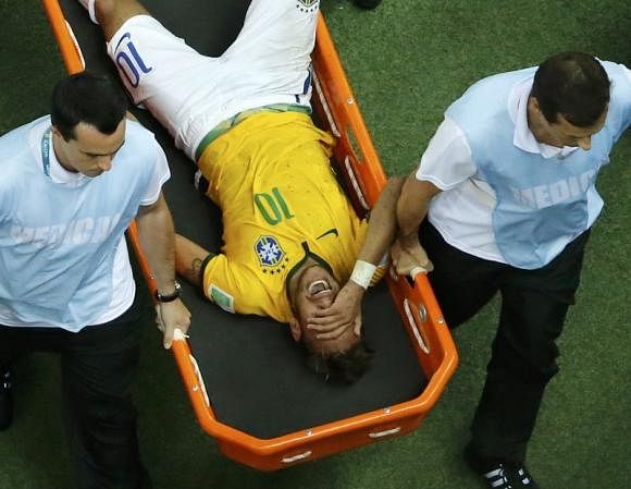 Brazil's Neymar grimaces as he is carried off the pitch after being injured during their 2014 World Cup quarter-finals against Colombia at the Castela