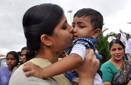 An Indian nurse, who was among 46 nurses stranded in territory held by Islamic extremists in Iraq, kisses her nephew upon arrival at the airport in Kochi, India, Saturday, July 5, 2014. The nurses who had been holed up for more than a week in Tikrit, returned home to southern India on Saturday aboard a special flight, officials said. AP photo